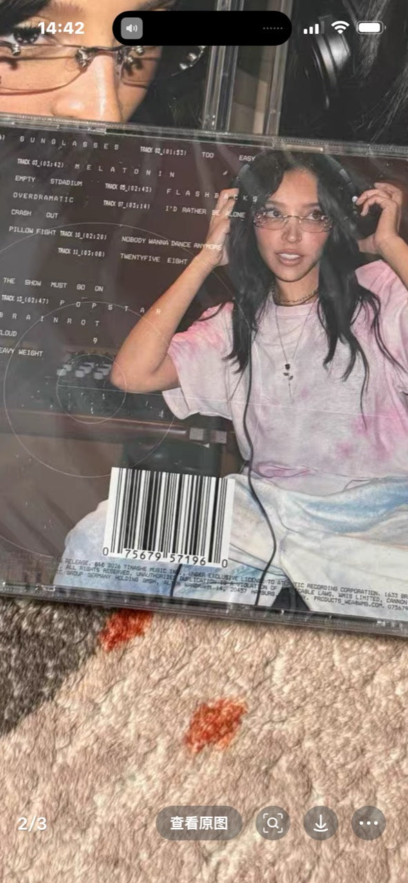 Seller-supplied photograph of the sealed CD back cover; signed card inside is not visible